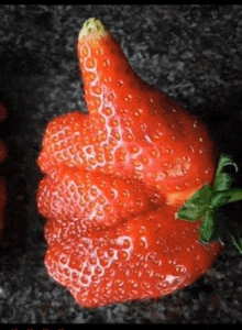 a strawberry in the shape of a thumbs up sign