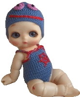 a baby doll is wearing a blue knitted outfit and a hat