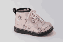 a pair of pink boots with unicorns on them