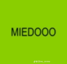 a green background with the word miedoo written on it .