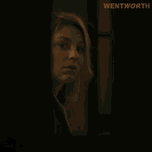 a close up of a woman 's face with the word wentworth on the bottom right