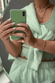 a woman is taking a picture of herself in a mirror with her phone