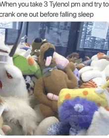 a bunch of stuffed animals are stacked on top of each other in a room