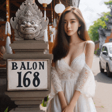 a woman in a white dress stands in front of a sign that reads balon 168