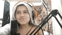 a girl wearing headphones and a towel on her head