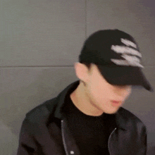 a blurry picture of a man wearing a black hat and a black jacket