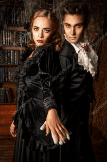 a man and a woman dressed as vampires are posing for a photo