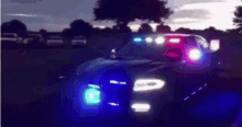 a police car is driving down the road at night