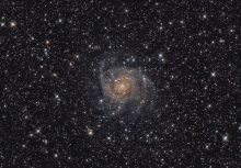 a spiral galaxy in the middle of a dark night sky