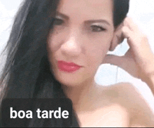 a close up of a woman 's face with the words boa tarde written below her