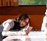 a girl wearing glasses is looking at her phone with the words " deseo cuando no se trata d nanu " written above her