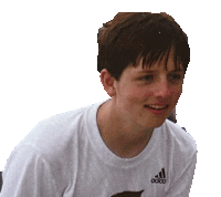 a young boy wearing a white adidas shirt looks at the camera