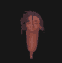 a blurred image of a man 's head with dreadlocks