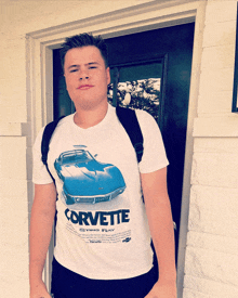 a young man wearing a white corvette t-shirt