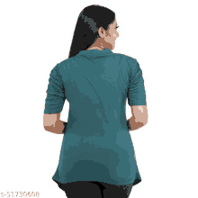 the back of a woman wearing a green shirt with ruffled sleeves