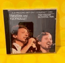 two men singing into microphones on a compact disc