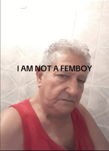 a man in a red tank top has the words " i am not a femboy " above him