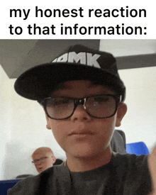 a young boy wearing glasses and a hat with the word amk on it