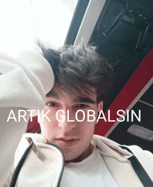 a man 's face is shown with the words artik globalsin on the bottom right