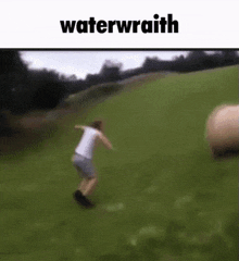 a person is jumping over a hay bale in a field with the words `` waterwrath '' written on the bottom .