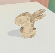 a statue of a rabbit on a white surface