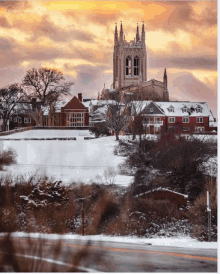 a large building with a steeple is surrounded by snow