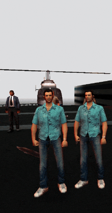 two men are standing in front of a helicopter