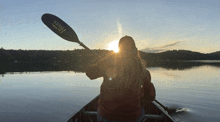 a person in a canoe with a kayak paddle that says ' kings ' on it