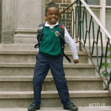 a little girl in a school uniform is standing on a set of stairs with netflix written on the bottom