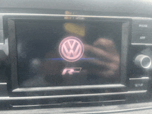 a volkswagen logo is on the screen of a car radio