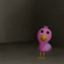 a pink flamingo toy is standing in the dark in a room .