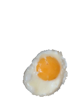 a close up of a fried egg on a white surface