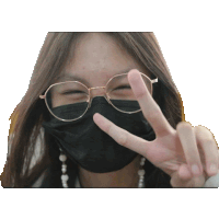 a woman wearing glasses and a black mask is giving a peace sign