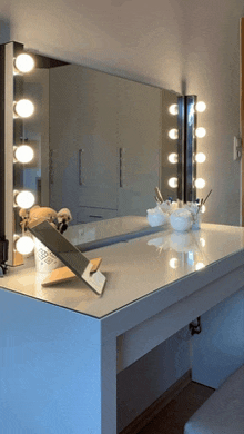 a vanity with a mirror and brushes on it and a container of powder