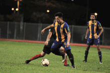 a soccer player wearing a blue and yellow jersey with the number 18 on it