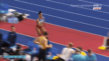 a woman is jumping in the air on a track with the words women 's long jump final on the bottom