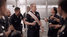 a police officer with a sash that says mrs. irrelevant