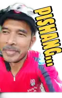 a man wearing a helmet and a red shirt with a sticker that says ' pisang '