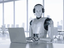 a robot wearing headphones is using a laptop