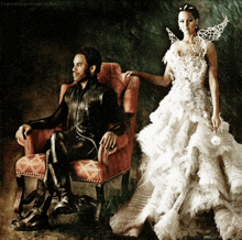 a painting of a man sitting in a chair next to a woman in a wedding dress