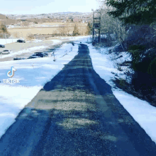 a snowy road with a tiktok watermark on the bottom