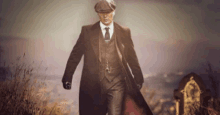 a man in a suit and hat is walking across a field