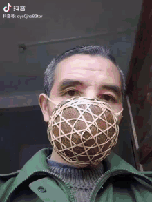 a man wearing a wicker face mask with chinese writing on it