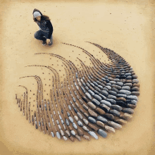 a woman is kneeling on a pile of rocks on the ground