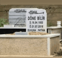 a grave in a cemetery with the name done bilir on it