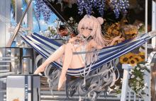 a girl is sitting in a hammock next to a suitcase that says le main