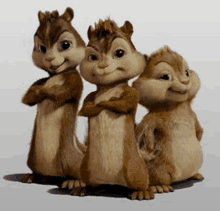 three cartoon chipmunks are standing next to each other with their arms crossed .