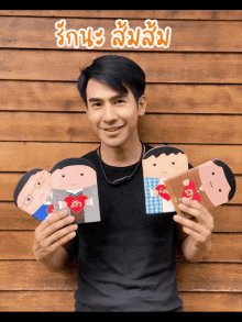 a man in a black shirt is holding three cards in his hands with the letters ls and rs on them