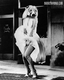 a woman in a white dress with a badger mask on her face