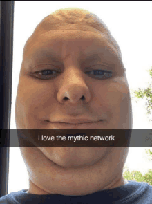 a man with a very large head is smiling and says i love the mythic network